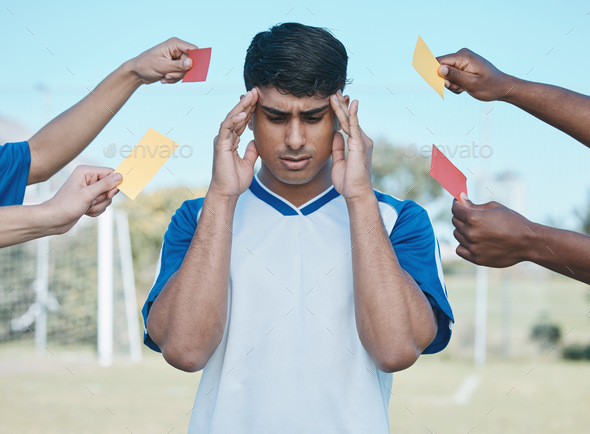 Hands, card and a man with headache from soccer, fitness stress and warning on the field. Sports, b