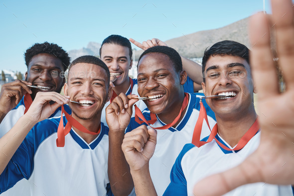 Men in selfie, medal and winner, soccer competition and sports, athlete group on field, diversity a