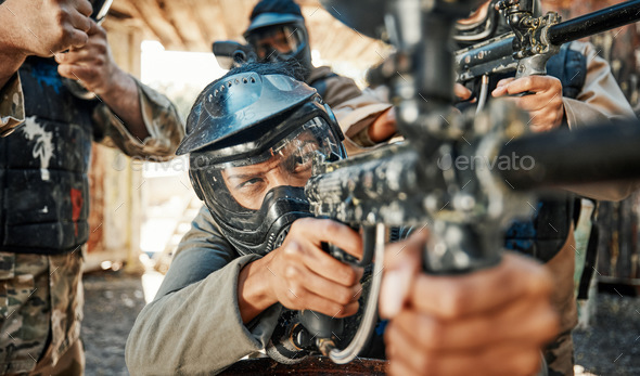 Paintball game, gun and man aim, shooting focus and target soldier, warrior  or training for battlef Stock Photo by YuriArcursPeopleimages