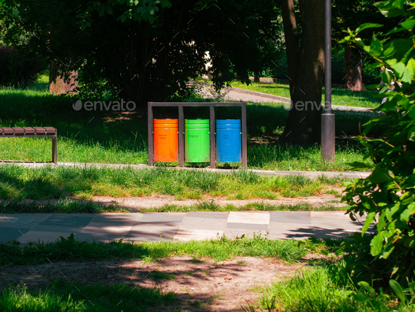 Colorful metal recycle trash bins for paper, glass, plastic and general waste public park urban area