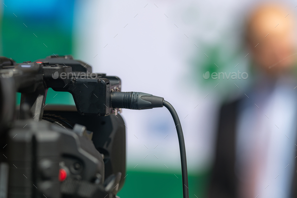 Close-Up of TV Camera Recording Press Conference