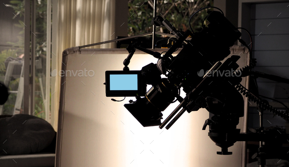 Silhouette images of video camera in tv commercial studio production