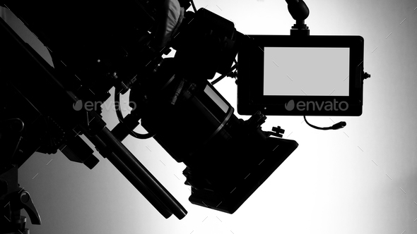 Silhouette images of video camera in tv commercial studio production