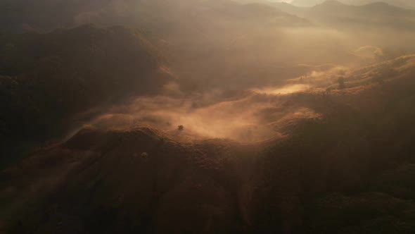 4K Aerial view from drone over mountains fog. Golden scenery at sunrise, Nan, Thailand alt