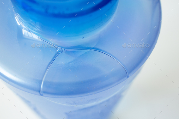 Bubble in blue bottle with facial skin tonic, close-up. Details cosmetic product