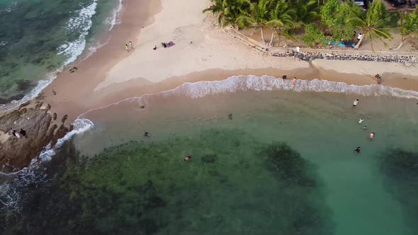 Small Tropical Beach with Rocky Point Aerial alt