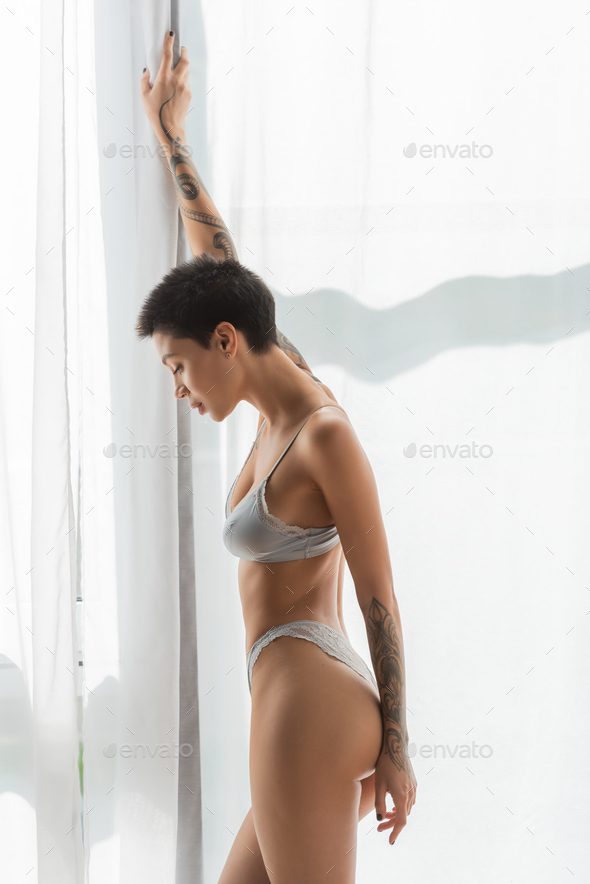 side view of irresistible woman with short brunette hair Stock Photo by  LightFieldStudios