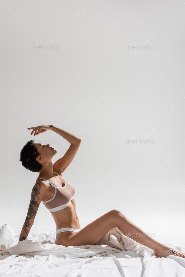 side view of sexy and charming woman in beige lingerie Stock Photo by  LightFieldStudios