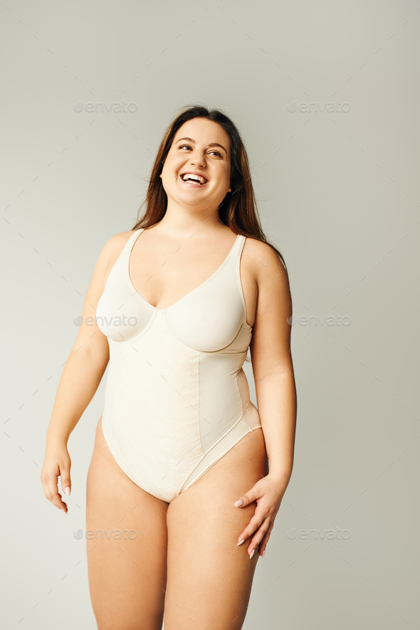 portrait of positive and curvy woman with plus size body posing in