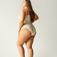 full length of brunette and curvy woman wearing beige bodysuit Stock Photo  by LightFieldStudios