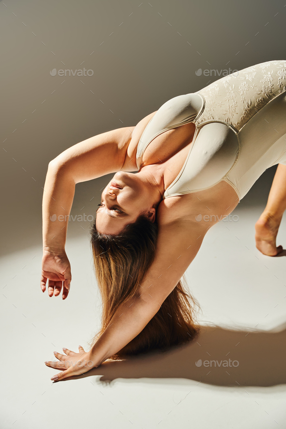 brunette plus size woman with long hair wearing beige bodysuit and doing  bridge exercise Stock Photo by LightFieldStudios