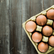 Eggs background. Closeup view of eggs in carton box on wooden table. Food and health concept. - PhotoDune Item for Sale