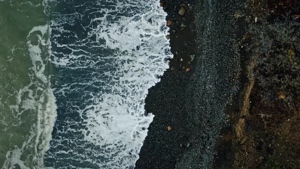 Surf on the Black Pebble Beach at the Foot of the Extinct Volcano Karadag