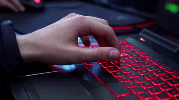 Hands on the keyboard with neon light. Esports. Championship in computer games. Streaming. alt