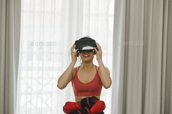 Virtual Fitness: Asian Woman Exercising at Home with Virtual Reality