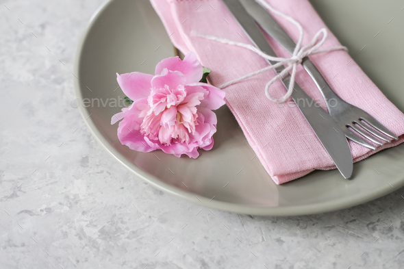 Close-up cutlery. Romantic table setting with pink peonies