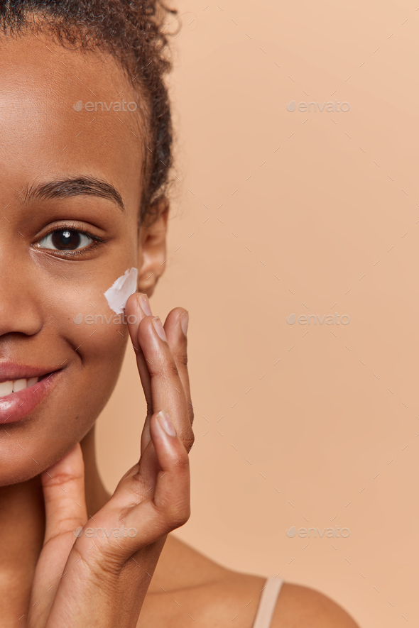 Half Face Of Tender Young African Woman Applies Facial Skin On Cheek For Care Massaging Face 3954