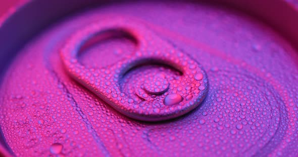 Beer can with water droplet with purple light alt