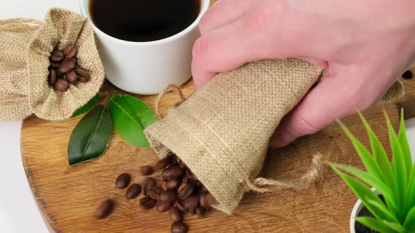 Coffee beans falling on wooden board