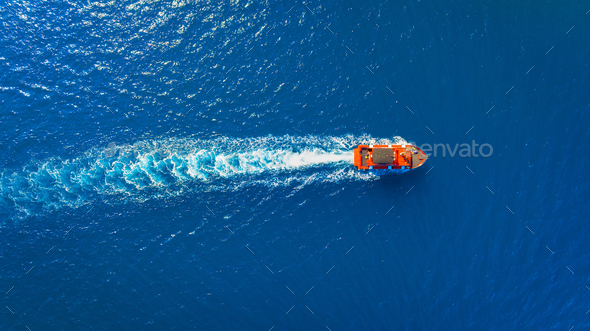 Vacation and leisure. Aerial view on fast boat on blue Mediterranean sea at sunny day.