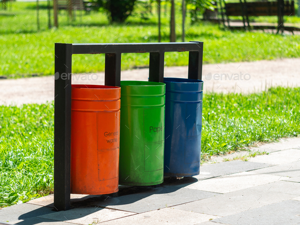 Colorful metal recycle trash bins for paper, glass, plastic and general waste public park urban area