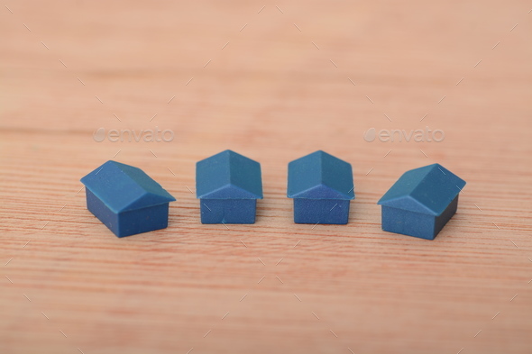 Blue plastic toy houses. concept of deposits and mortgages required by first-time home buyers