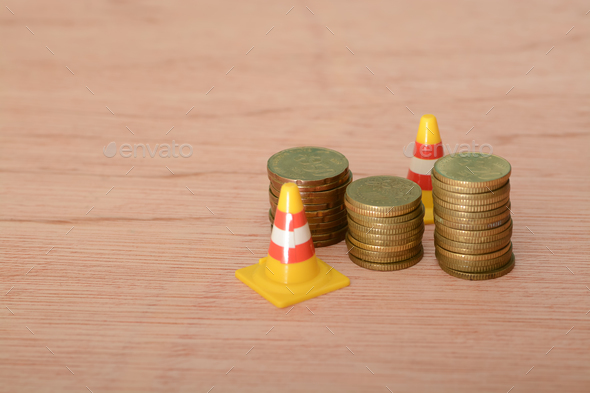  coins and safety cones: The concept of economic downturn, bankruptcy, economic situation impacting