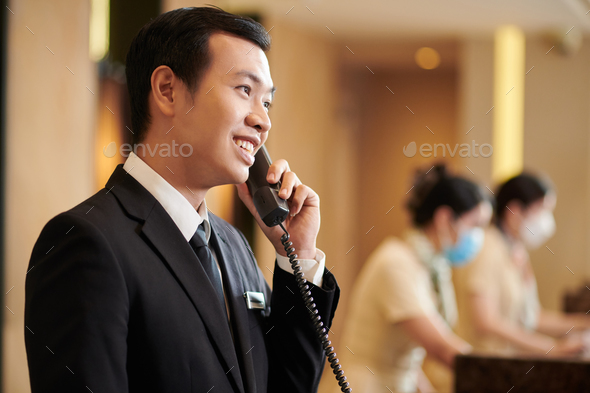Hotel Manager Answering Call from Guest