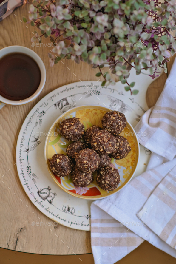 Vegan candies with nuts, raisins, dates, cocoa, coconut oil. Useful healthy homemade dessert