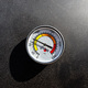 A round thermometer showing 70 degrees Celsius placed on a charcoal grill. - PhotoDune Item for Sale