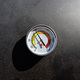 A round thermometer showing 100 degrees Celsius placed on a charcoal grill. - PhotoDune Item for Sale