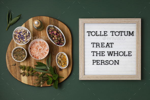 Letter board with text Tolle totum meaning treat the whole person in latin. Naturopatical principle