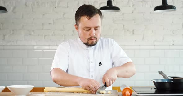 Chef Cuts Homemade Dough Roll for Traditional Italian Pasta Made Handmade