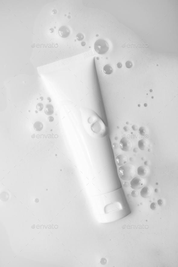 White plastic tube mockup with moisturizer cream, shampoo or facial cleanser in water