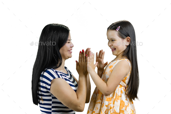 Young asian mother playing clapping game with her daughter.