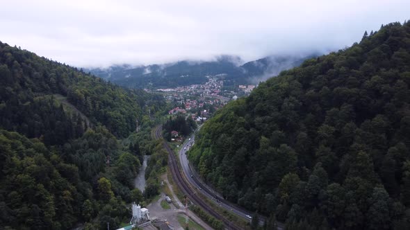 Aerial View of a Foggy Morning Close to the Railways Tracksroads and Small City