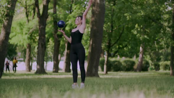 Woman Gymnast Trains with Ball alt