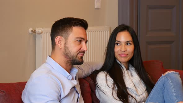 A young couple discussing content on a smartphone alt