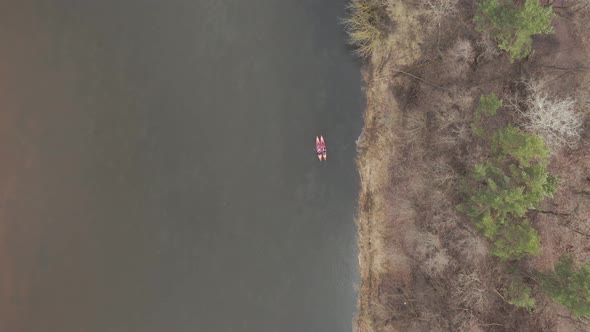 AERIAL: Kayakers Swimming Close to Each Other on a River in Early Spring Time