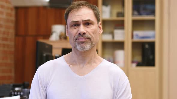 Shaking Head to Reject No By Middle Age Man in Office alt