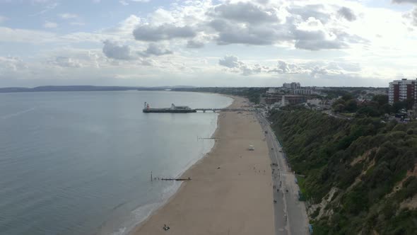Dolly back drone shot over Bournemouth Promenade alt