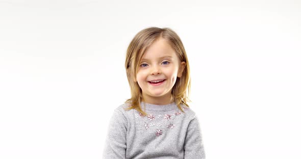 Beautiful Happy Fun Young Child Blond Smarty Girl Smiling and Making Faces