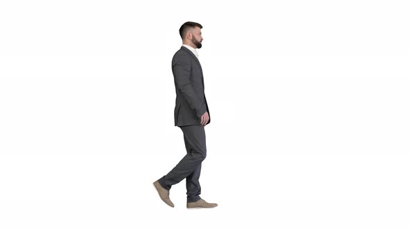 Serious Businessman in Formal Suit Walking on White Background