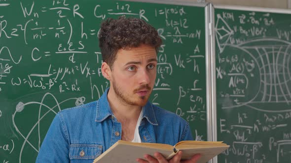 Medium Shot of Teacher with Book Holding Math Class alt