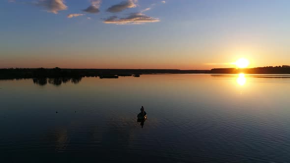 People in the Rowing Boat, Sunset on a Lake or River - Drone Footage alt