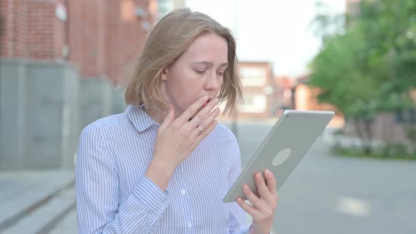 Portrait of Woman Having Loss on Tablet While Walking in Street alt