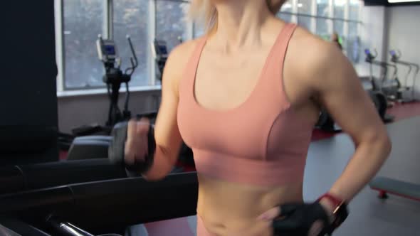 Young woman training on treadmill