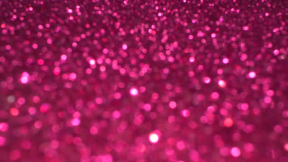 Shiny magenta surface rotates. Magic bokeh background alt