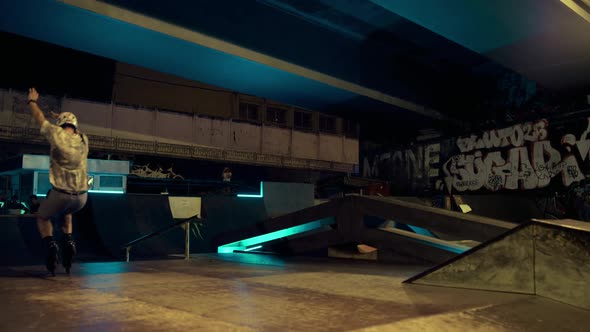 Sporty Men Training Together on Ramp at Skate Park with Graffiti Wall alt