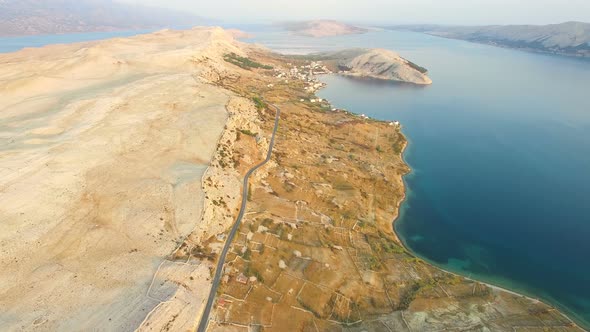 Aerial view of road through barren landscape of Pag island in Croatia alt